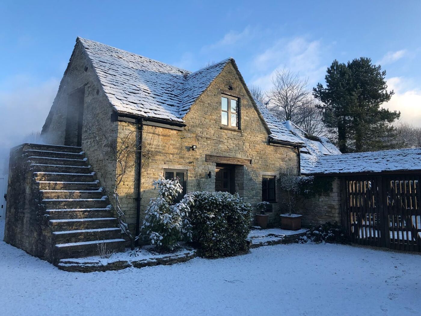 A Cotswold stone cottage dusted in snow